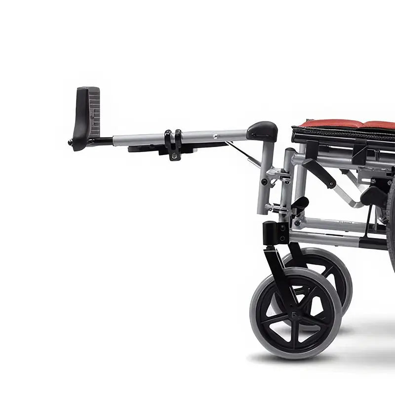 This image focuses on the lower part of the KM-5000 F14 wheelchair, highlighting the adjustable footrest. The footrest extends outward, showing its capability to accommodate different leg positions and lengths. The sturdy design of the footrest ensures that it can provide adequate support and comfort for the user's legs and feet. The wheelchair's frame is shown to be robust, with large rear wheels and smaller front wheels for stability and ease of movement.