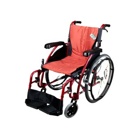 The image depicts a manual wheelchair with a bright red frame and orange seat and backrest padding. The wheelchair has large rear wheels equipped with hand rims for self-propulsion, and smaller front caster wheels for maneuverability. It includes armrests and footrests, which appear to be adjustable and foldable. The overall design looks modern and lightweight, suitable for everyday use.