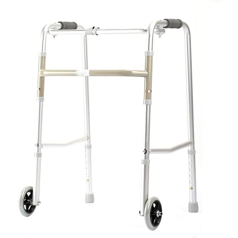  shows a silver-colored, wheeled walker designed to aid mobility. The walker features two front wheels and two leg supports with rubber tips for stability. It has an adjustable height mechanism, visible on the legs, which allows the walker to be customized to the user’s height for comfort and better support. The hand grips are ergonomically shaped and covered with gray foam for a soft, non-slip grip. 